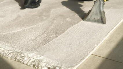 CLOSE UP: Fresh and clean woven floor carpet after thorough spring deep cleaning. Revealing clean fabric at washing and vacuuming of rug with electric household accessories during spring-cleaning.