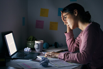 Laptop, night and tired with a student woman learning or studying in her home for a university...