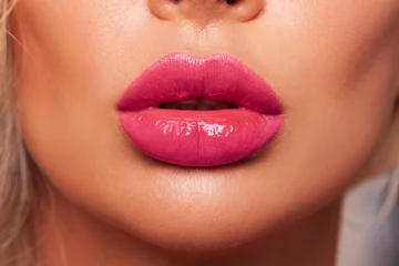 Fotobehang Sexy pink lips close up. Beautiful Perfect Makeup. Macro. Beautiful pink Lip Gloss. Advertising. Cosmetic.Mouth open, big lips.  © Julia