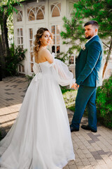 the groom leads the bride by the hand along the path. 