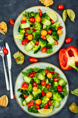 Green vegan salad decorated physalis.