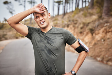 Fototapeta premium Tired, fitness and running man portrait of a marathon runner on a road feeling fatigue from workout. Exercise, athlete and sports person breathing from a health, wellness and cardio training