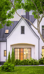 3d rendering of cute cozy white and black modern Tudor style house with parking  and pool for sale or rent with beautiful landscaping. Fairy roofs. Clear summer evening with cozy light from window