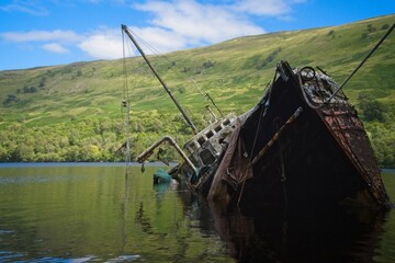 Wreck of a fishing boat on the shallows of Loch Oich near the ruins of Invergarry Castle - 563905752