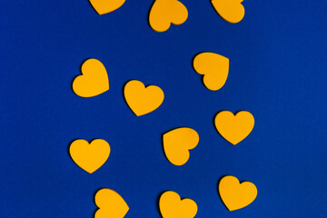 Yellow hearts on blue background.  Abstract composition with the colors of Ukrainian flag