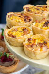 Tartlet stuffed. Baked with cheese. Traditional cold portioned appetizer in a pastry basket.