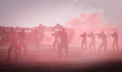 Fototapeta premium Practice special Forces soldiers in action. The military forces are shooting enemies. Soldier use special equipment, weapons and tactical devices. preparation for battle. practicing combat shooting.