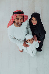 Top view of young arabian muslim family wearing traditional clothes