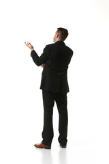 Back view. Businessman in a suit standing, thinking, considering ideas over white studio background. Concept of business, career, innovations, ad