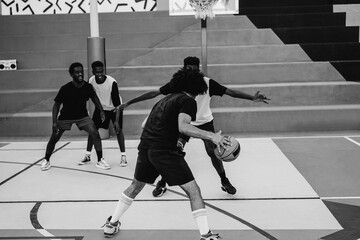 African friends playing basketball outdoor - Focus on right guy hands - Black and white editing