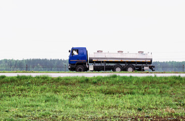 Truck milk tanker transports milk on the highway. Farming, copy space for text. Industry
