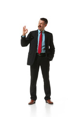 Businessman in a suit showing gesture of Ok, approvement and positivity over white studio background. Success. Concept of business, career, innovations, ad