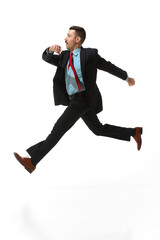 Businessman in a suit with positive mood walking to work over white studio background. Reaching goals. Concept of business, career, innovations, ad