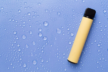 Disposable electronic cigarette on color background, top view