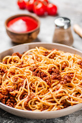 Spaghetti bolognese with cherry tomatoes on the table.
