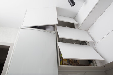 Organization of storage of utensils in the kitchen. Modern headset and planning for the manufacture of a section and drawers in the kitchen. Convenience of the location of dishes.