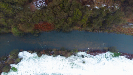 Forest landscape, amazing river view taken by drone from the top. river flowing in the forest and historical old bridge