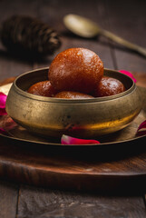 Gulab jamun is made with deep-fried balls of milk base dough soaked in sugar syrup, very popular dessert in the Indian sub-continent.