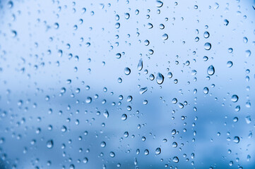 rain drops on blue glass background. Autumn abstract background