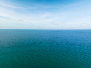 Aerial view of a blue sea surface water texture background and sun reflections Aerial flying drone...