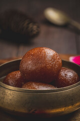 Gulab jamun is made with deep-fried balls of milk base dough soaked in sugar syrup, very popular dessert in the Indian sub-continent.