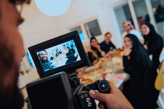 Professional videograph recording video while Muslim family having iftar together during Ramadan