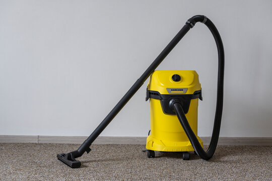 Kyiv, Ukraine - Jan 23, 2023: Karcher WD 3 V wet and dry vacuum cleaner. Yellow Karcher vacuum cleaner in home, close up