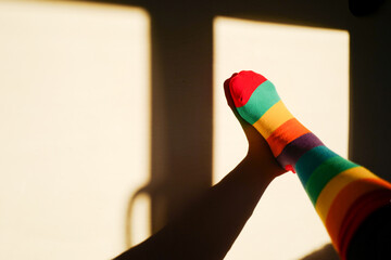 feet with rainbow sock symbolizing lgtbi+, abstract photograph with copyspace, comfortable...