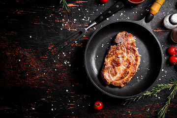 Frying pan with grilled steak. 