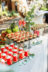 Large assortment of appetizers for an event in restaurant. Glass food stand