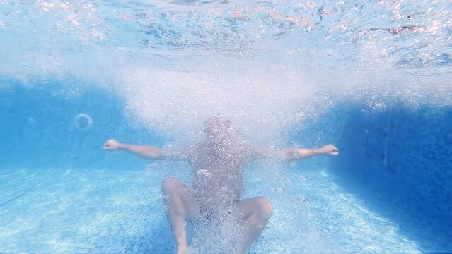 Drowning man floats underwater view, slow motion