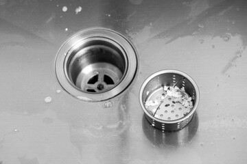 Protective mesh filter in a metal sink in the kitchen from blockage. Clogged sink with food...