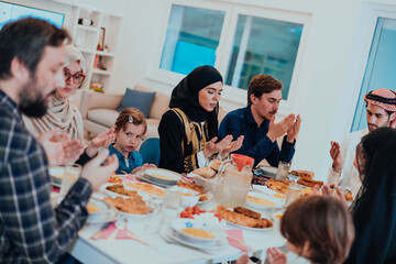 A Muslim family praying together, the Muslim prayer after breaking the fast in the Islamic holy month of Ramadan