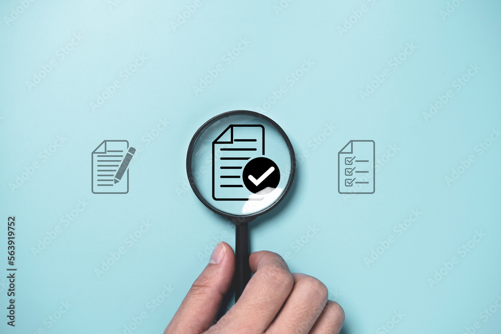 Poster hand holding magnifier glass with correct sign and document for prepare check and approve document ,
