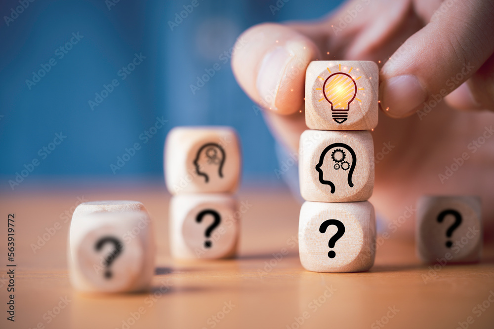 Poster hand putting wooden cube block stacking which print screen glowing light bulb and question mark with