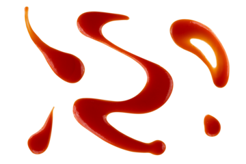 Red drops and splashes of ketchup or sauce isolated on white background. With clipping path. Full depth of field. Focus stacking. PNG