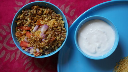 Spicy Misal Pav or usal Pav is a traditional and popular snack or Chat food from Maharashtra, India. Served with chopped onion, lemon wedges and farsan.Selective focus with copy space
