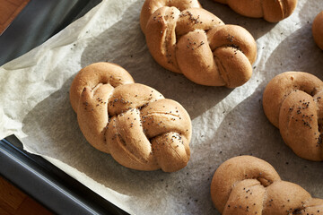 Fresh braided bread buns made from whole grain spelt flour