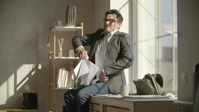 Angry man throws a stack of documents and screams. Tired, emotional office worker yelling after analyzing the papers. High quality FullHD footage