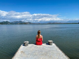 Girl sitting outdoors, relaxing , meditation, recreation with an amazing natural landscape.