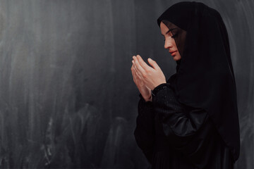 Portrait of young Muslim woman making dua