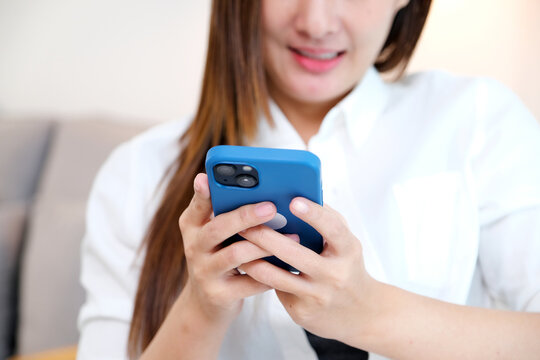Close up of young asian woman using phone with smiling, happy and relax emotion, Happy asia girl on phone, people and technology, lifestyle