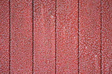 Red wooden wall with ice crystals