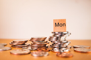 Monday wooden block on stack coins using as business and financial concept - Vintage filter