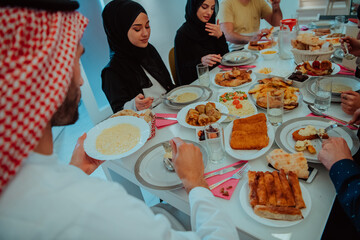  Muslim family having Iftar dinner drinking water to break feast. Eating traditional food during Ramadan feasting month at home. The Islamic Halal Eating and Drinking in modern home 