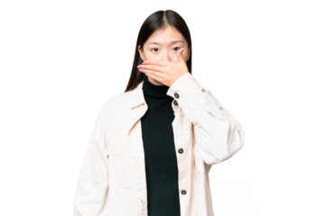 Young Asian woman over isolated chroma key background covering mouth with hand