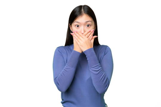 Young Asian woman over isolated chroma key background covering mouth with hands