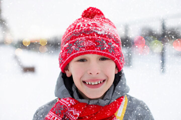 Portrait of a happy little boy in winter, he is smiling and looking at the camera.