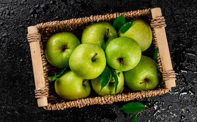 Fresh green apples in a basket. 