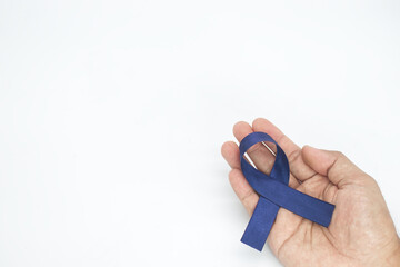 hand holding dark Blue Ribbon  on white background